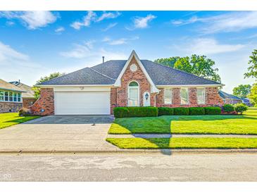 Charming brick home with well-manicured lawn and two-car garage under a bright, sunny sky at 817 S Jefferson St, Brownsburg, IN 46112