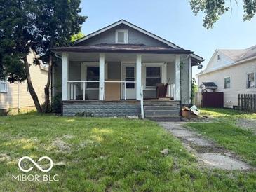 Charming home featuring a welcoming front porch and a classic architectural design at 822 W 7Th St, Muncie, IN 47302