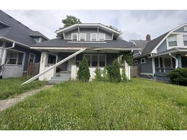 Gray two-story home with a black shingle roof and front yard at 917 N Rural St, Indianapolis, IN 46201