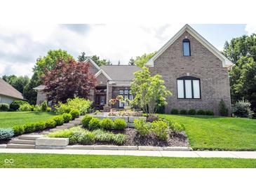 Beautiful brick home featuring meticulously landscaped front yard and well-maintained lawn at 10707 Burning Ridge Ln, Fishers, IN 46037