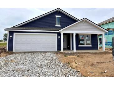 Charming, newly constructed, navy home with a white garage door, set in a landscaped yard and eye-catching curb appeal at 1175 Mcbride St, Greenfield, IN 46140