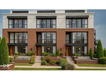 Beautiful brick townhomes with large windows and landscaped front yards provide a modern and inviting street view at 11972 Citywalk Dr, Fishers, IN 46038