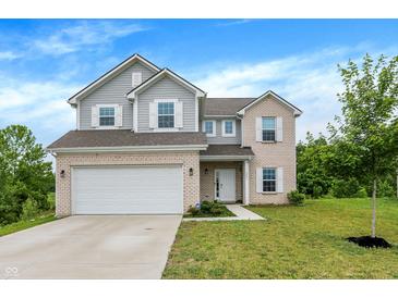 Charming two-story home with brick and siding, attached two-car garage and well-maintained lawn at 1571 N Creekwater Pass, Greenfield, IN 46140