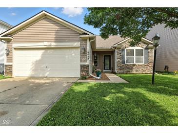 Charming single-Gathering home with attached garage, stone accents, and well-maintained lawn at 19489 Prairie Crossing Dr, Noblesville, IN 46062