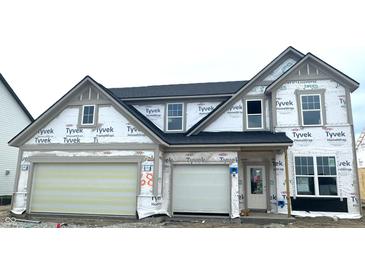 New two-story home showcasing a modern elevation with attached two-car garage, still under construction phase at 19976 Stone Side Dr, Westfield, IN 46074