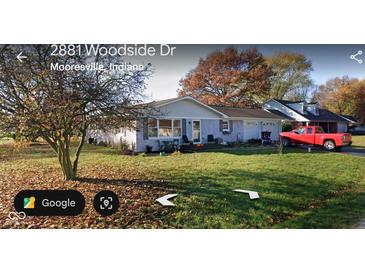 Charming single-story home with attached garage and well-maintained lawn in a suburban setting at 2875 E Woodside Dr, Mooresville, IN 46158
