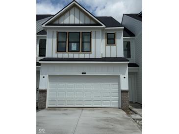 Modern two-story home features a white garage door, complementary trim, and black-framed windows at 3307 Noriker Ln, Zionsville, IN 46077