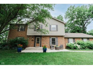 Charming two-story home with brick and siding facade, complemented by a well-manicured lawn at 46 Hawthorne Ct, Carmel, IN 46033