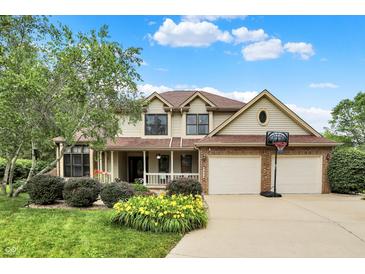 Charming two-story home with well-manicured lawn and a basketball hoop in front of the two-car garage at 6050 Acorn Dr, Columbus, IN 47201