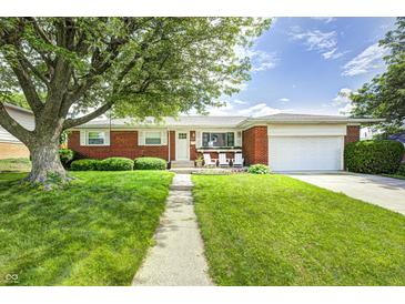 Charming brick home with a well-maintained lawn and mature trees, perfect for curb appeal at 6143 Schoolwood Dr, Indianapolis, IN 46224