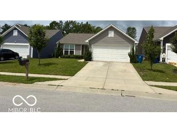 Charming single-story home featuring a well-maintained lawn and an attached two-car garage at 6926 Trey Dr, Indianapolis, IN 46113
