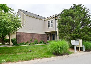 Charming two-story home with a brick and vinyl exterior, featuring a well-manicured lawn and mature trees at 9477 Aberdare N Dr, Indianapolis, IN 46250