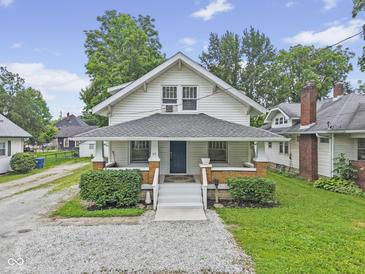Charming two-story home with a inviting front porch and landscaped yard at 113 N Munsie St, Indianapolis, IN 46229