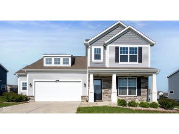 Charming two-story home featuring a two-car garage and a welcoming front porch at 1328 Plover Dr, Greenwood, IN 46143