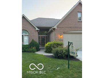 Charming brick home featuring a well-manicured lawn and inviting front entrance, perfect for a Gathering at 1870 Broadleaf Ct # 10, Greenwood, IN 46143