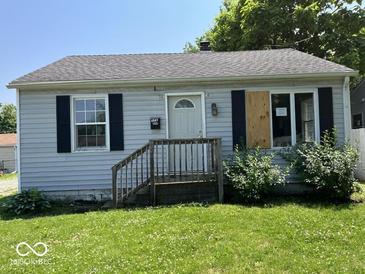 Charming single-story home with light blue siding and black shutters shows potential at 2507 S Keystone Ave, Indianapolis, IN 46203