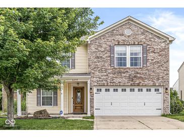 Inviting two-story home featuring a brick facade, attached two-car garage, and a well-maintained lawn at 6259 Teacup Dr, Indianapolis, IN 46235