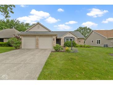 Charming single-story brick home with a well-manicured lawn, a two-car garage, and inviting curb appeal at 786 Woodview North Dr, Carmel, IN 46032