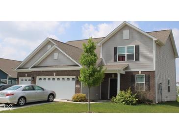 Charming two-story home featuring vinyl siding, brick accents, and an attached two-car garage at 9068 Thames Dr, Avon, IN 46123