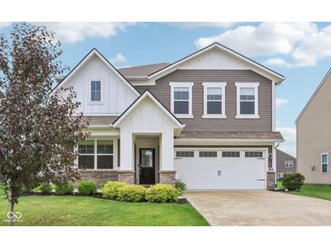 Charming two-story home featuring a well-manicured lawn, white trim, and a two-car garage at 9498 Tobin Cir, Avon, IN 46123