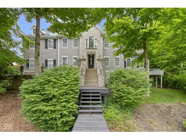 Charming home featuring stone accents, well-maintained landscaping, and inviting entrance stairs at 9985 Ford Valley Ln, Zionsville, IN 46077