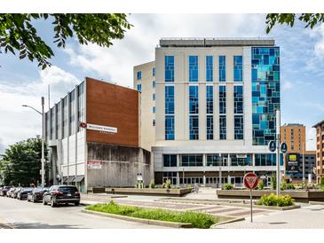 Modern commercial building with blue-tinted windows and inviting landscaping at 1 Virginia Ave # 607, Indianapolis, IN 46204