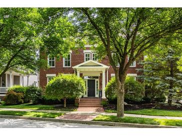 Charming brick two-story home with a well-manicured lawn and lush landscaping, creating an inviting curb appeal at 12505 Branford St, Carmel, IN 46032