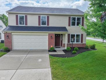 Charming two-story home boasts a two-car garage and well-manicured lawn at 15460 Follow Dr, Noblesville, IN 46060