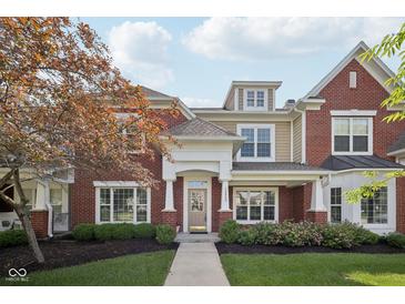Charming brick home with a well-manicured lawn and inviting front entrance at 15553 Portland Dr, Westfield, IN 46074