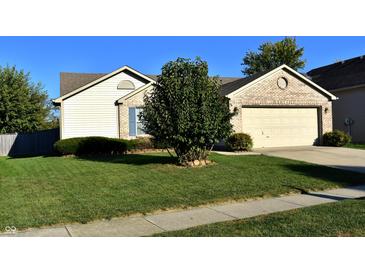 Charming single-story home featuring a well-manicured lawn and a two-car garage at 1896 Central Park W Blvd, Greenwood, IN 46143