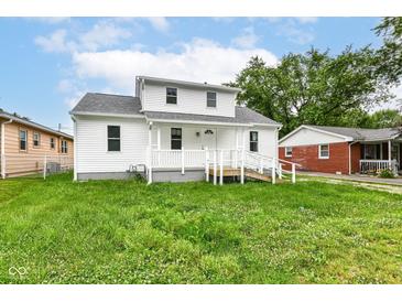 Charming two-story home features a welcoming porch, landscaped yard, and bright white siding at 2413 Fowler St, Anderson, IN 46012