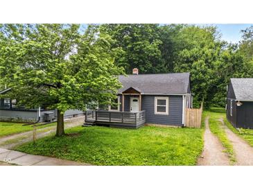 Charming single-story home featuring a covered front porch and mature landscaping at 3422 Hillside Ave, Indianapolis, IN 46218
