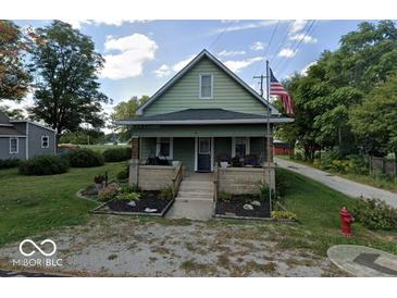 Charming two-story home features a cozy front porch and a well-maintained lawn and landscaping at 50 Pearl St, Cicero, IN 46034