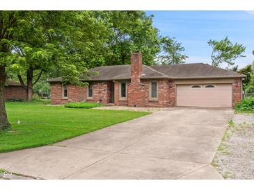 Charming brick ranch home with a well-manicured lawn and a paved driveway leading to an attached garage at 9189 Dawn Dr, Brownsburg, IN 46112
