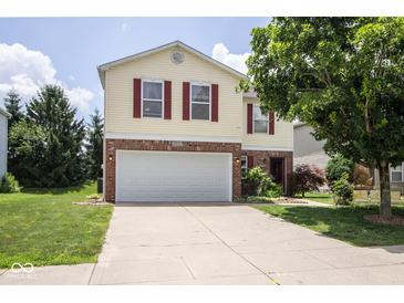 Charming two-story home featuring a brick-accented front and attached two car garage at 9215 Stones Bluff Pl, Indianapolis, IN 46113