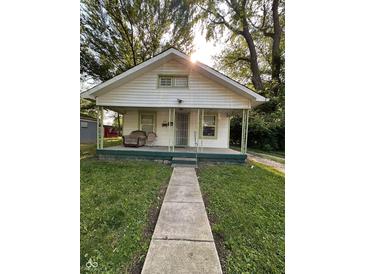 Charming bungalow featuring a covered porch, green trim, and inviting curb appeal at 1728 N Somerset Ave, Indianapolis, IN 46222