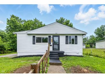 Charming one-story home with white siding, black shutters, and a well-maintained front yard at 1933 Tallman Ave, Indianapolis, IN 46218