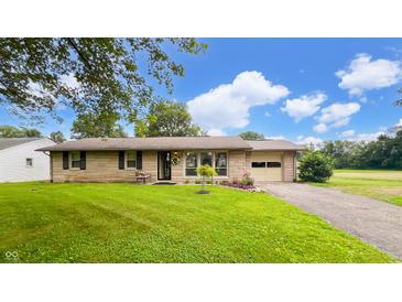 Charming single-story home with well-maintained lawn and inviting curb appeal, featuring a convenient attached garage at 202 Collier St, Columbus, IN 47201