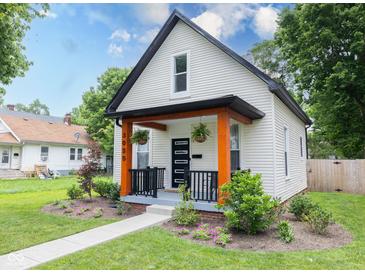 Charming renovated bungalow featuring black trim, bright orange porch supports, and fresh landscaping at 3035 Guilford Ave, Indianapolis, IN 46205