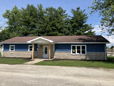 Charming single-story home with blue siding, stone accents, and a welcoming front porch at 321 S 23Rd St, Elwood, IN 46036