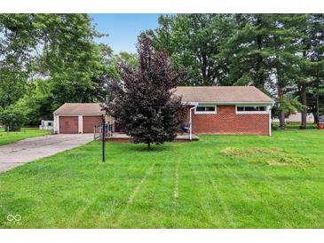 Charming brick home with a well-maintained lawn and a detached two-car garage at 3921 S Lasalle St, Indianapolis, IN 46237