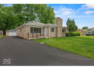 Charming single-story home featuring a stone facade, well-manicured lawn, and a paved driveway at 508 W 38Th St, Indianapolis, IN 46208