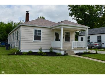 Charming single-story home with a front porch, manicured lawn, and fresh landscaping at 5430 E 17Th St, Indianapolis, IN 46218