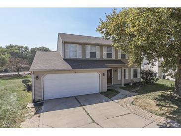Charming two-story home with a two car garage, neutral siding and attractive landscaping at 6214 Weller Cir, Indianapolis, IN 46268