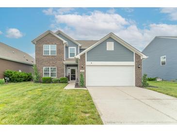 Charming two-story home with a brick and vinyl facade, landscaped yard, and attached two-car garage at 6737 Trey Dr, Camby, IN 46113