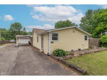Charming single-story home with a well-maintained yard, a covered carport, and classic curb appeal at 6805 Jackson St, Indianapolis, IN 46241