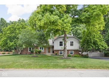 Charming two-story home with landscaped yard and mature trees at 7629 Candlewood Ln, Indianapolis, IN 46250