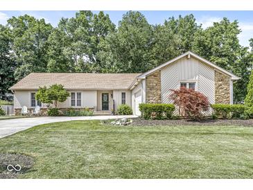 Charming single-story home with a well-manicured lawn, stone accents, and an inviting, curved driveway at 792 Nevelle Ln, Carmel, IN 46032
