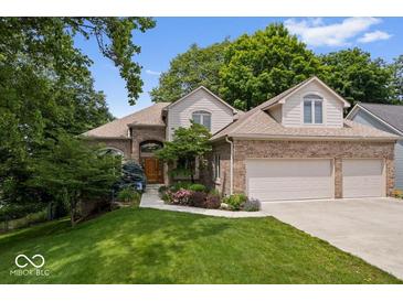 Charming brick home with a well-manicured lawn and lush landscaping at 817 Hickory Way, Noblesville, IN 46062