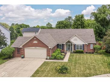 Charming single-story brick home with manicured lawn and lush landscaping at 10306 Tybalt Dr, Fishers, IN 46038